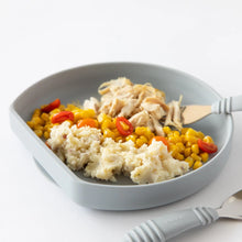 Load image into Gallery viewer, Close-up of Bumkins Silicone Grip Plate: Gray filled with chicken, corn, and potatoes on a white background.; a gray fork and spoon nearby.
