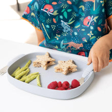 Load image into Gallery viewer, Close-up of a child eating star-shaped sandwiches, snacks, &amp; berries from a Bumkins Silicone Grip Tray: Gray at a white table.
