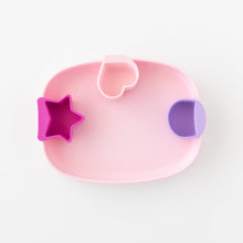 Load image into Gallery viewer, Bumkins Silicone Little Dipper 3-Pack: Lollipop hang on the inside edge of a rounded rectangular pink plate on a white background.
