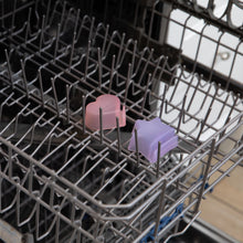 Load image into Gallery viewer, Bumkins Silicone Little Dipper Combo 2 Pack: Magenta Jelly sits in the top rack of an open dishwasher.
