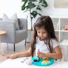 Load image into Gallery viewer, A young girl at a table enjoys fruit and eggs with a fork from a plate with a Bumkins Silicone Little Dipper Combo 2 Pack: Magenta Jelly.
