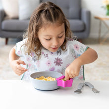 Load image into Gallery viewer, A child eats cereal from a gray bowl with a fuchsia Bumkins Silicone Little Dipper 3-Pack: Lollipop attached at a white table.
