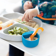 Load image into Gallery viewer, Close-up of a blue Bumkins Silicone Little Dipper Round 3-Pack: Gumdrop with dip and a bell pepper slice attached to a gray plate of food.
