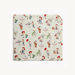Magnetic Me, Toy Story Woody & Friends Blanket: cream blanket with colorful Toy Story character pattern; made of TENCEL modal.