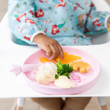 Load image into Gallery viewer, A child in a high chair enjoys a meal from Bumkins Silicone Plate + Spoon Set: Disney Princess with broccoli, mashed potatoes, and nuggets.
