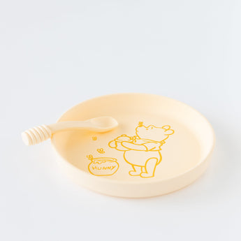 Bumkins Silicone Plate + Spoon Set: Disney Winnie the Pooh rests on a white background.
