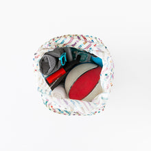 Load image into Gallery viewer, Top view of an open Bumkins Packable Tote Bag: Mickey &amp; Friends Varsity on a white background with a basketball, sunglasses, and rolled-up towel inside.
