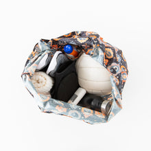 Load image into Gallery viewer, Top view of a Bumkins Packable Tote Bag: Ghostly Gallery containing a volleyball, bottle, towel, shoes, socks &amp; deodorant on a white background.
