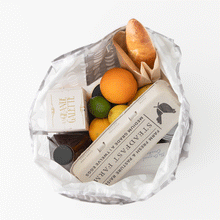 Load image into Gallery viewer, Groceries remove themselves from a Bumkins Packable Tote Bag: Lunar Phase on a white background in a stop motion GIF.
