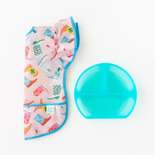 Load image into Gallery viewer, Bumkins Ruffle Apron Bib: Boots lays folded next to a blue transparent divided plate on a white background.
