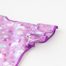 Load image into Gallery viewer, Close-up of Bumkins Ruffle Apron Bib: Unicorns laid flat on a white background, with focus on the ruffle sleeve.
