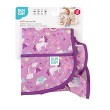 Load image into Gallery viewer, Bumkins Ruffle Apron Bib: Unicorns is shown folded in its packaging.

