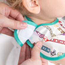 Load image into Gallery viewer, Close-up of a person fastening the hook and loop closure of Bumkins SuperBib® 3 Pack: Mickey &amp; Friends MVP on a toddler.
