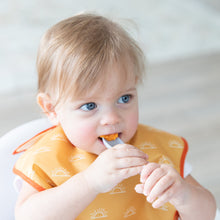 Load image into Gallery viewer, A boy in a yellow bib eats mashed sweet potatoes with a Bumkins Silicone Dipping Spoons 3 Pack: Taffy.
