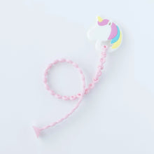 Load image into Gallery viewer, A Bumkins Silicone Accessory Tether 2-Pack: Pink attached to a unicorn-shaped teether on a white background.

