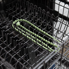 Load image into Gallery viewer, Bumkins Silicone Accessory Tether 2-Pack: Sage sits in the top rack of an open dishwasher.
