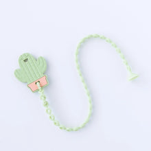 Load image into Gallery viewer, A Bumkins Silicone Accessory Tether 2-Pack: Sage attached to a cactus-shaped teether on a white background.
