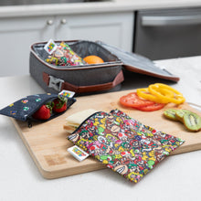 Load image into Gallery viewer, Bumkins Reusable Snack Bag, 3-Pack: Super Mario™ Power Up holds a sandwich &amp; berries on a kitchen counter by an open lunch bag.
