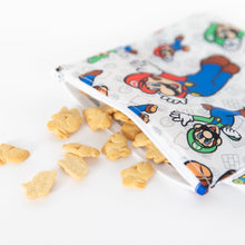 Load image into Gallery viewer, Close-up of bunny-shaped crackers spilling from a Bumkins Reusable Snack Bag, Large: Super Mario™ &amp; Luigi on a white background.
