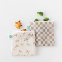 Load image into Gallery viewer, Bumkins Reusable Snack Bag, Large 2 Pack: Palm Check holding broccoli and cookies on a white background.
