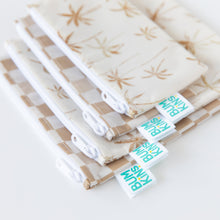 Load image into Gallery viewer, Close-up of Bumkins Reusable Snack Bag, Large 2 Pack: Palm Check, displayed stacked underneath similar bags on a white background.
