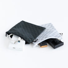 Load image into Gallery viewer, Roamio by Bumkins Reusable Snack Bag, Large 2 Pack: Rich &amp; Boujee lays open on a white background with electronics peeking out.

