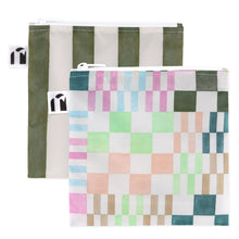 Load image into Gallery viewer, Roamio by Bumkins Reusable Snack Bag, Large 2 Pack: Motley Club—2 waterproof pouches, one with green &amp; white stripes, one with colorful squares.
