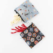 Load image into Gallery viewer, Bumkins Reusable Snack Bag, Large 2 Pack: Everyday Is Halloween sits on a white background; one holds popcorn, the other red licorice.
