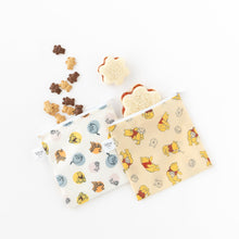 Load image into Gallery viewer, Bumkins Reusable Snack Bag, Large 2 Pack: Pooh Bear and Friends on a white background with cookies and sandwiches spilling out from inside.
