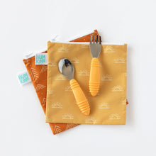 Load image into Gallery viewer, Bumkins Reusable Snack Bag, Large 2-Pack: Sunshine and Grounded lay overlapped on a white background, with yellow utensils on top. 
