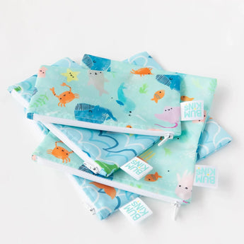 Bumkins Reusable Snack Bag, Large 2-Pack: Ocean Life & Whale Tail lays stacked on top of other similar bags on a white background.