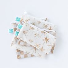 Load image into Gallery viewer, Bumkins Reusable Snack Bag, Small 2 Pack: Palm Check lays stacked on top of other similar bags on a white background.
