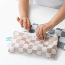 Load image into Gallery viewer, A child zips Bumkins Reusable Snack Bag, Small 2 Pack: Double Check at a white table.
