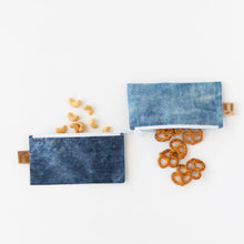 Load image into Gallery viewer, Cashews and pretzels spill out of Roamio by Bumkins Reusable Snack Bag, Small 2 Pack: Denim on Denim on a white background.

