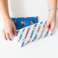 Load image into Gallery viewer, Hands hold Bumkins Reusable Snack Bag, Small 2 Pack: Mickey &amp; Friends MVP at a white table.
