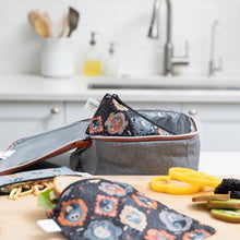 Load image into Gallery viewer, A Bumkins Reusable Snack Bag, Small 2 Pack: Everyday Is Halloween sits in a gray lunch bag on a kitchen counter, surrounded by food.
