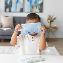 Load image into Gallery viewer, A child in a white shirt holds a Bumkins Reusable Snack Bag, Small 2 Pack: Stitch Star-ring Up Trouble in front of their face at a white table.
