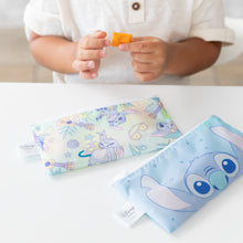 Load image into Gallery viewer, A child holds a cracker above Bumkins Reusable Snack Bag, Small 2 Pack: Stitch Star-ring Up Trouble on a white table.
