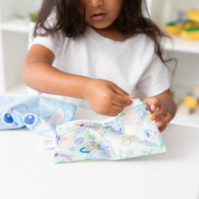 Load image into Gallery viewer, A child in white shirt unzips a Bumkins Reusable Snack Bag, Small 2 Pack: Stitch Star-ring Up Trouble at a white table.
