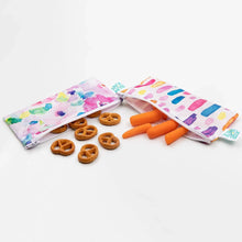 Load image into Gallery viewer, Pretzels and carrots spill from Bumkins Reusable Snack Bag, Small 2-Pack: Watercolor &amp; Brush Strokes on a white background.

