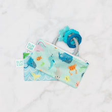 Load image into Gallery viewer, Bumkins Reusable Snack Bag, Small 2-Pack: Ocean Life &amp; Whale Tail holds a blue teething toy on a marble background.
