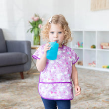 Load image into Gallery viewer, A child with curly hair in a unicorn bib drinks from a Bumkins Silicone Straw Cup with Lid: Blue.
