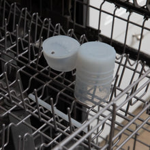 Load image into Gallery viewer, Bumkins Silicone Straw Cup with Lid: Gray sits in the top rack of an open dishwasher.

