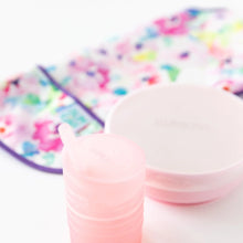 Load image into Gallery viewer, Bumkins Silicone Straw Cup with Lid: Pink sits on a white background, with a pink bowl and floral bib blurred behind.
