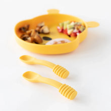 Load image into Gallery viewer, Bumkins Silicone Dipping Spoons: Winnie the Pooh sit on a white background, with a blurred bear-shaped plate of food behind.
