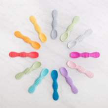 Load image into Gallery viewer, Bumkins Silicone Dipping Spoons 3 Pack: Tutti-Frutti lays flat on a marble background with other colorful spoons in a circular pattern.

