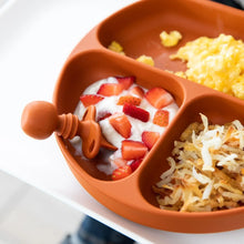 Load image into Gallery viewer, Clay silicone divided plate with eggs, yogurt, and hash browns, plus a Bumkins Silicone Chewtensils® baby spoon for BLW.
