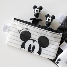Load image into Gallery viewer, Bumkins Silicone Chewtensils®: Mickey Mouse peeks out from a Mickey Mouse-themed waterproof pouch on a white background.
