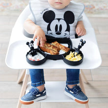 Load image into Gallery viewer, A baby in a high chair enjoys toast, eggs, and fruit from a Mickey Mouse-shaped plate using Bumkins Silicone Chewtensils®: Mickey Mouse.
