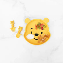 Load image into Gallery viewer, A yellow bear-shaped plate with colorful food and yogurt, paired with Bumkins Silicone Chewtensils®: Winnie The Pooh on a marble background.
